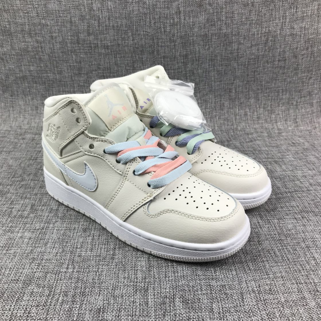 Pair of off-white high-top sneakers shown from a front three-quarter angle with pastel laces and perforated toe boxes.