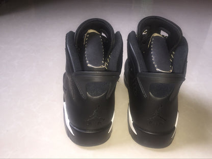 Rear view of the black high-top sneakers showing padded collars, heel tabs, and Jordan Air branding.