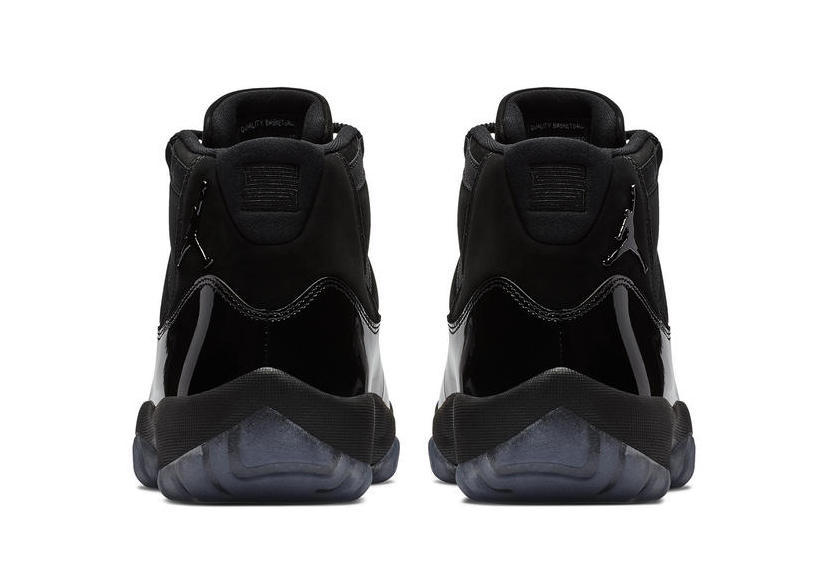 Studio rear view of a pair of black high-top sneakers.
