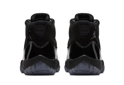 Studio rear view of a pair of black high-top sneakers.