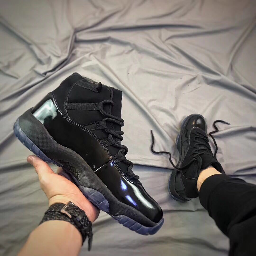 Black high-top sneaker shown at an angled side view with glossy toe and side panels.