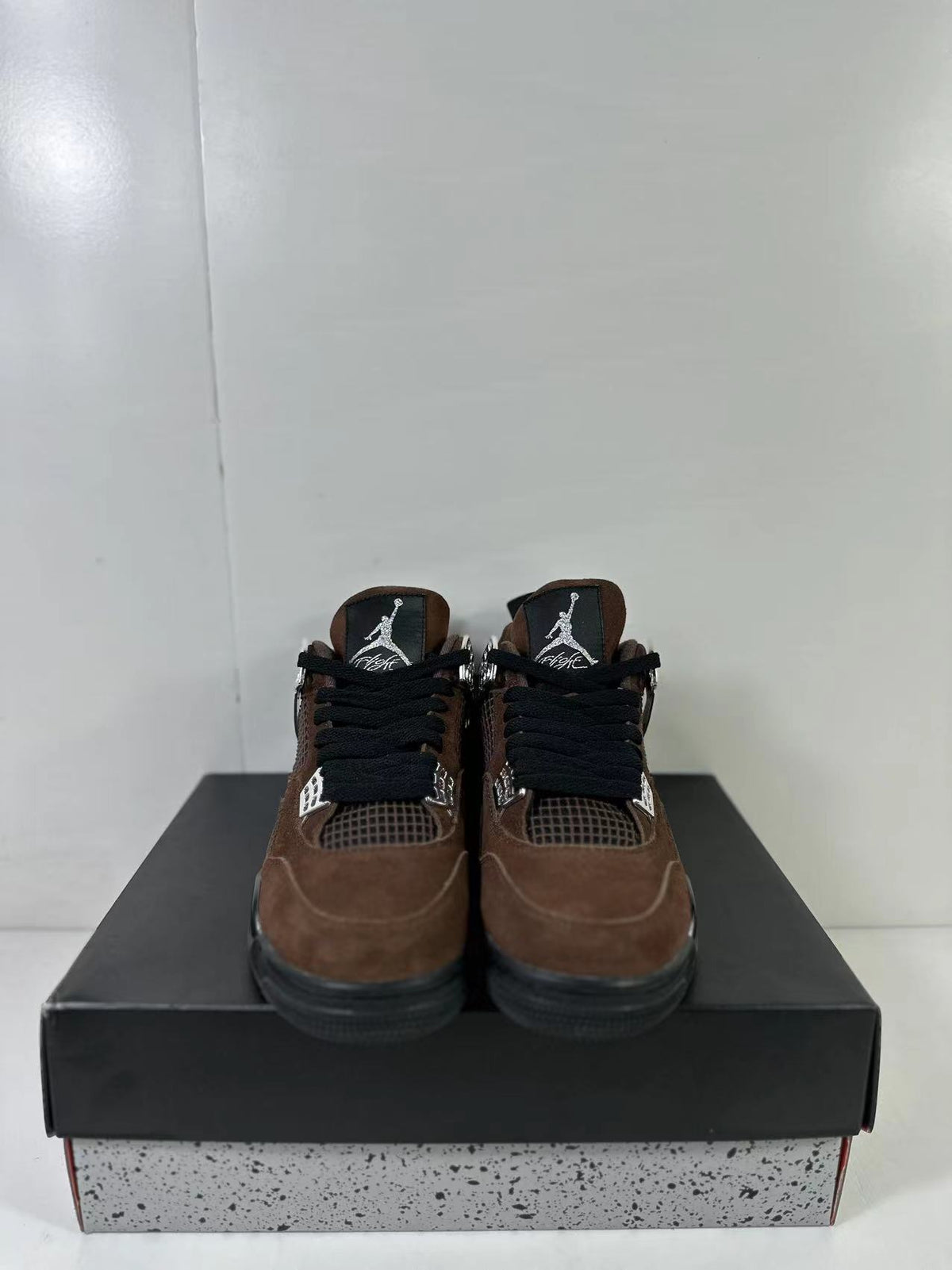 Front view of the pair showing black laces, brown toe panels, mesh tongues, and contrasting logos.