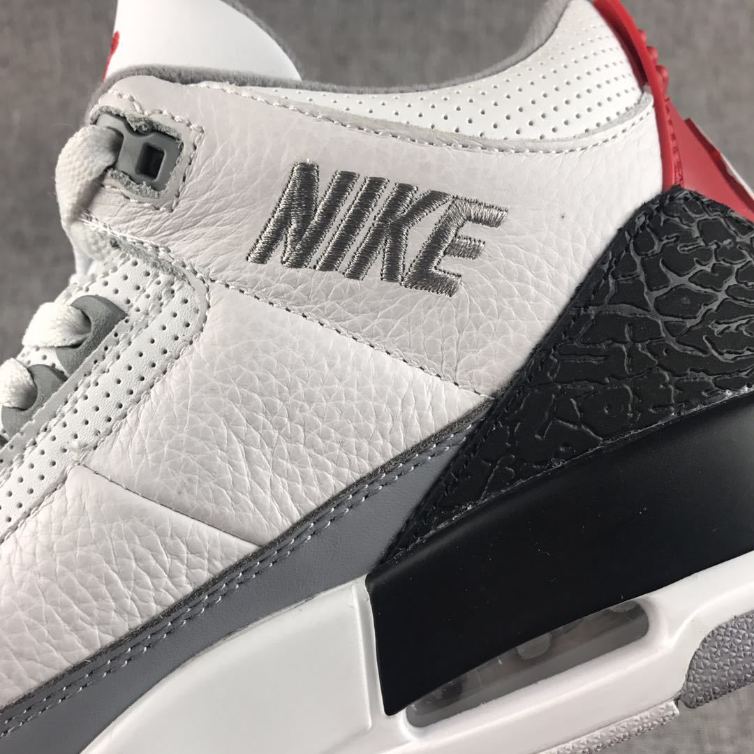 Close-up of the white textured upper, stitched Swoosh, black elephant-print overlay, and visible air window.