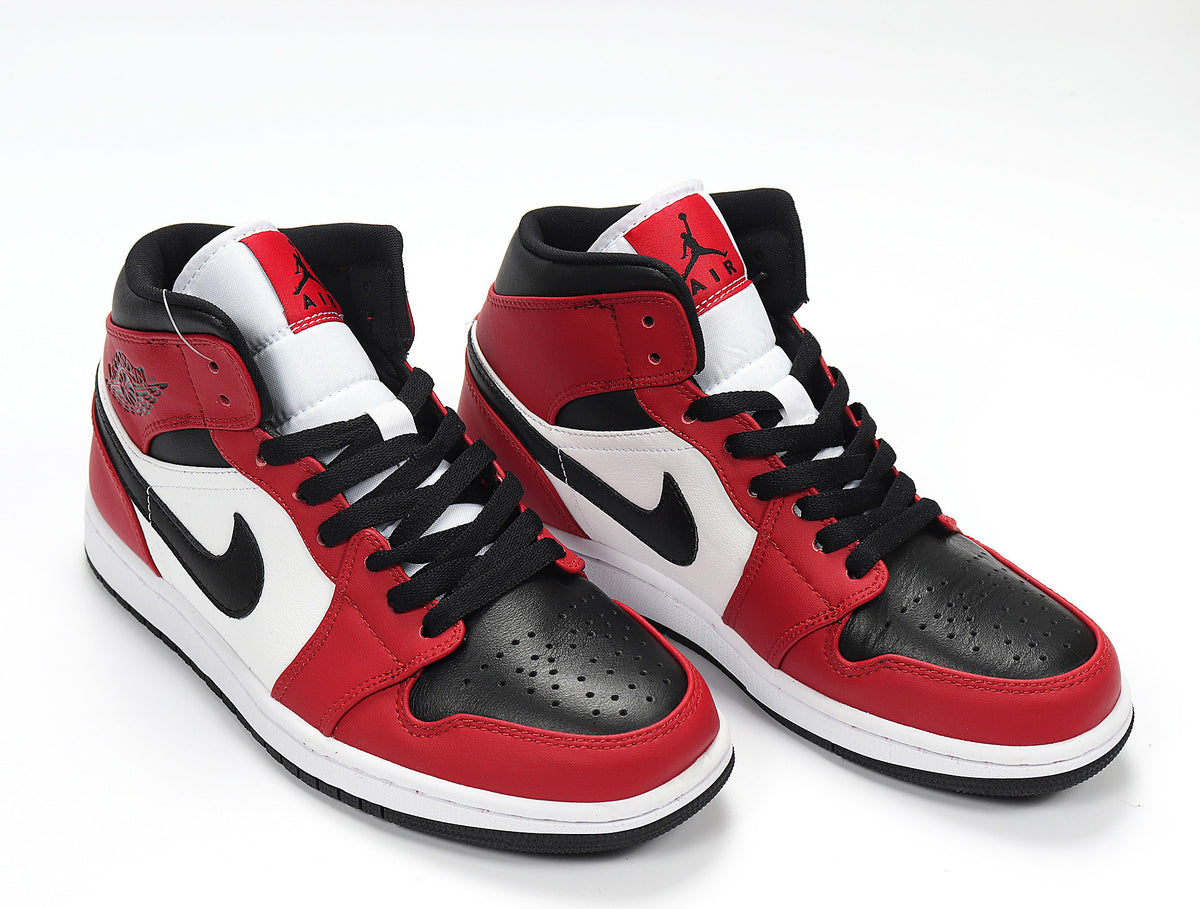 Three-quarter view of the high-top sneakers with visible side branding and layered panels