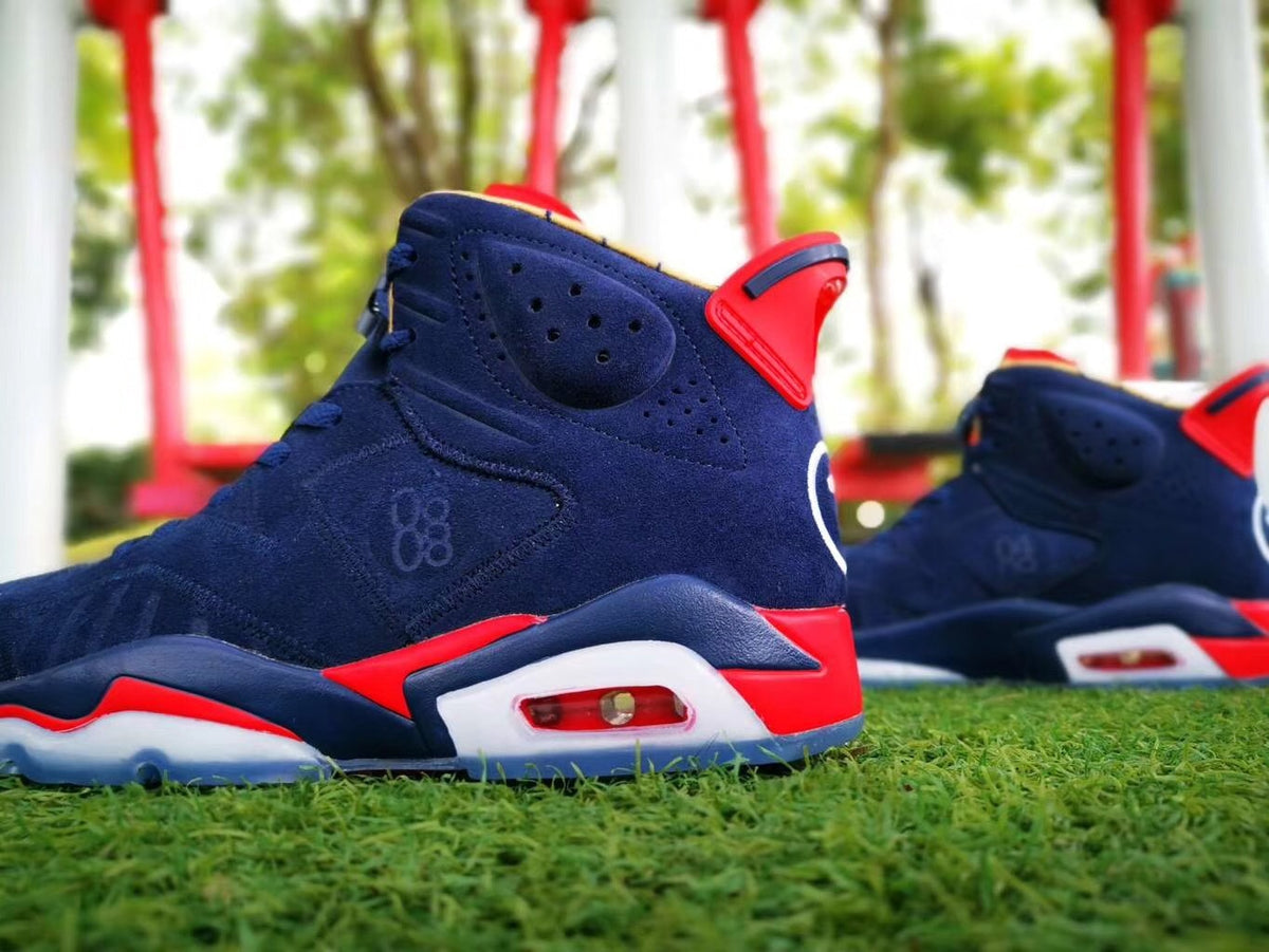 Side profile showing the navy upper, red and white midsole accents, and visible heel air unit.