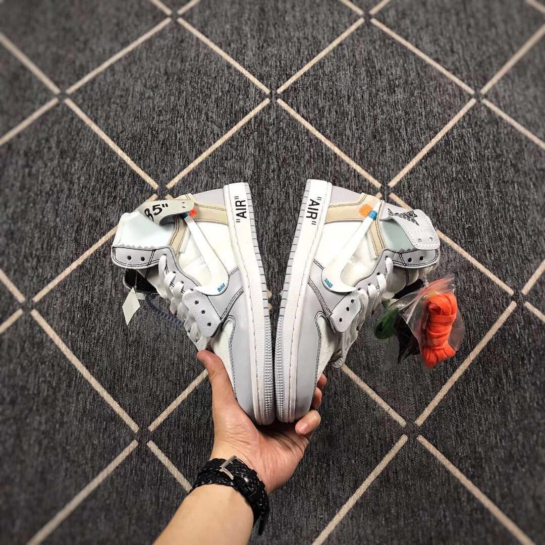 Front view of the pair showing matching grey overlays, white uppers and quoted AIR midsole text.