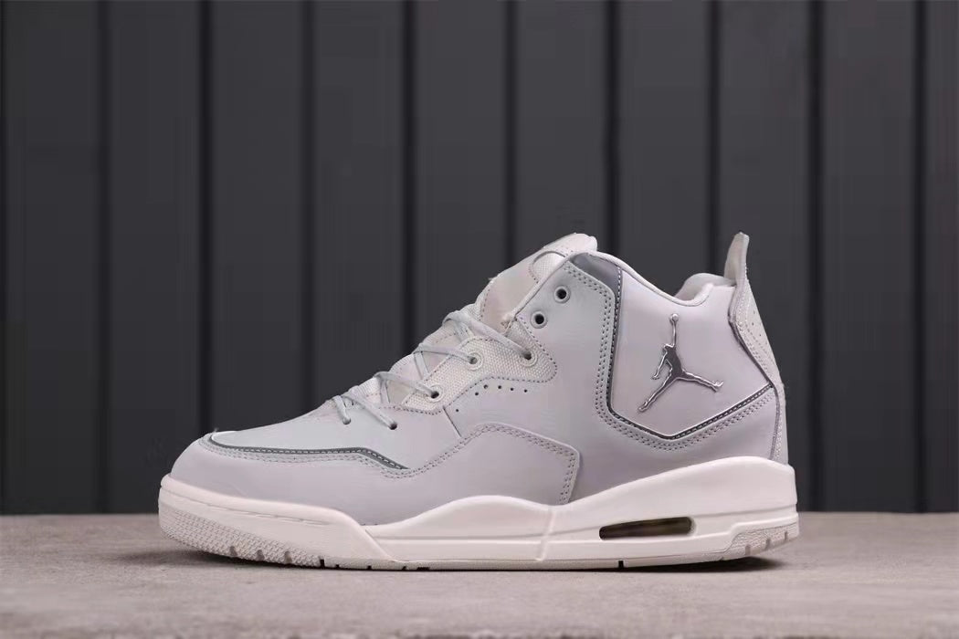 Side profile showing the metallic Jumpman logo, layered panels, laces, and outsole.