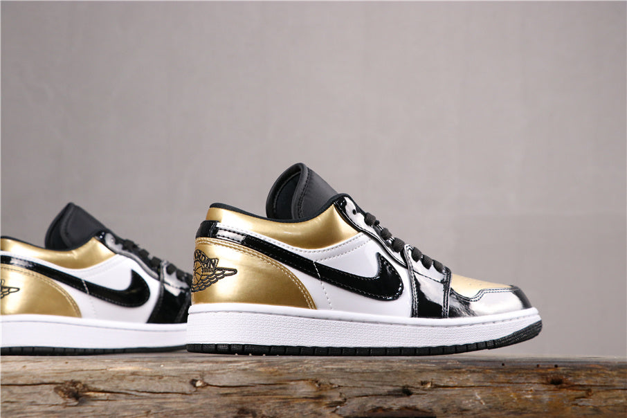 Side profile of the low-top sneaker showing metallic gold heel and collar accents, black overlays, white panels, and a white midsole.