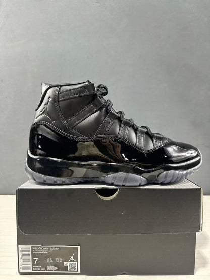 Black high-top sneaker displayed on its box with a visible label identifying Air Jordan 11 CDG SP, style code LV7639-001, and EU 40 sample sizing.