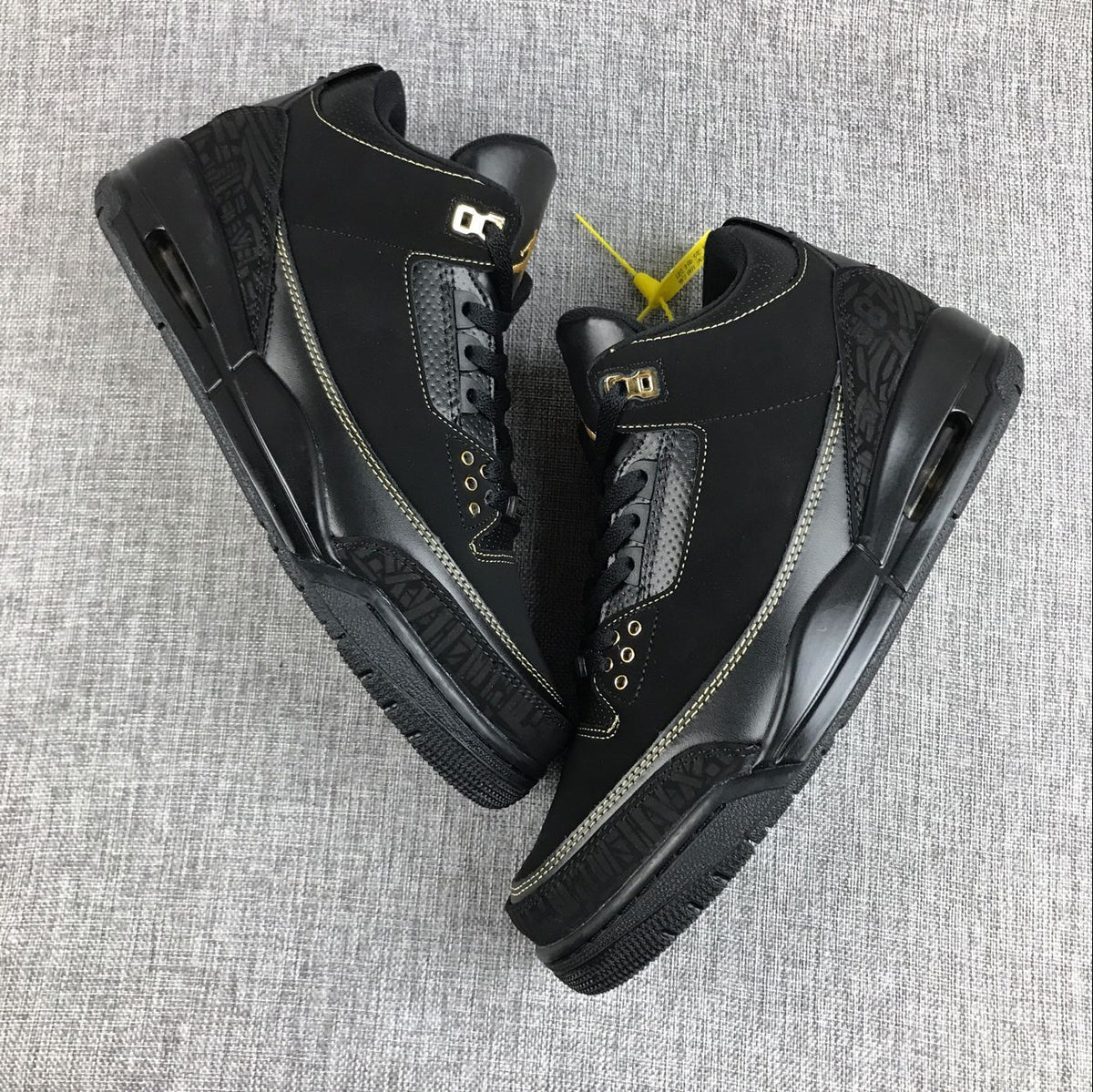Pair of black and gold Jordan Air Jordan 3 BHM sneakers