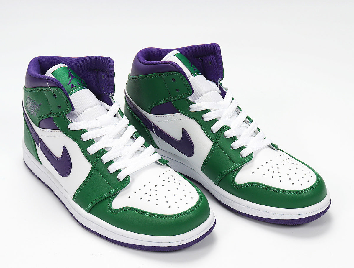 Angled view of green, white and purple high-top sneakers.